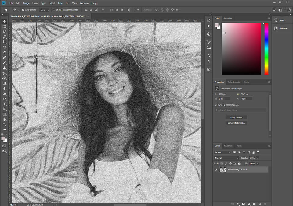 A grainy BMP of a woman in a white tank top and a straw hat open in Photoshop.