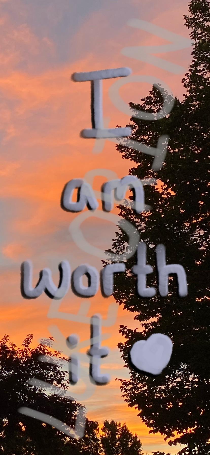 A colorful sunset serves as the background for the text "I am worth it" with a heart symbol, surrounded by silhouettes of trees.